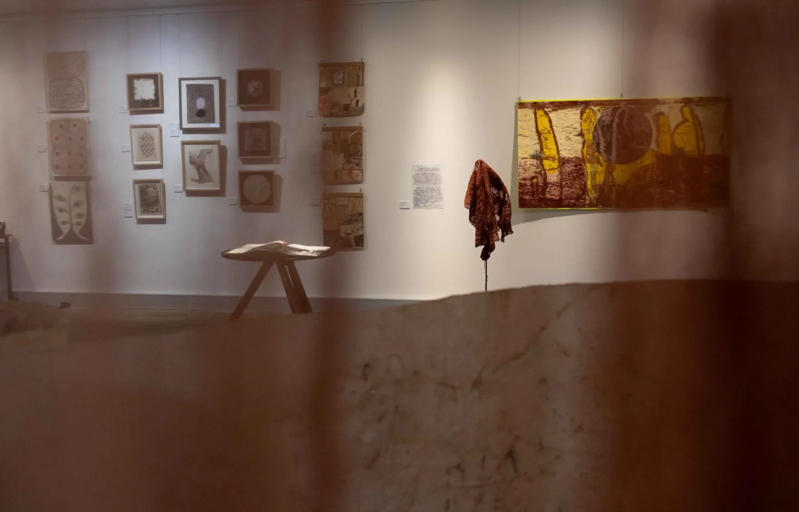 Installation showing artist book on stand, Audio work and woodblock. Series of drawings by Donna Malone